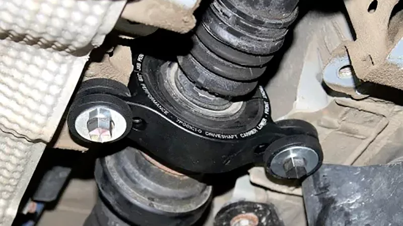 Installed center support bearing on driveshaft showing rubber mount and bracket condition