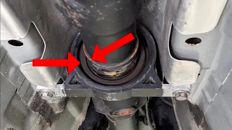Failed driveshaft center support bearing showing worn rubber mount