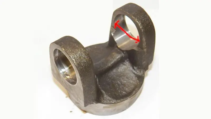 Worn driveshaft end yoke with an elongated U-joint bearing bore